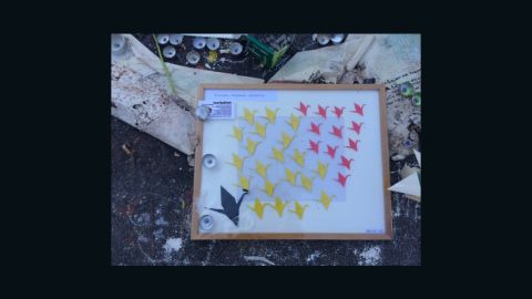 A message with birds in the colors of Belgium's flag was left at the memorial Place de la Bourse in central Brussels.