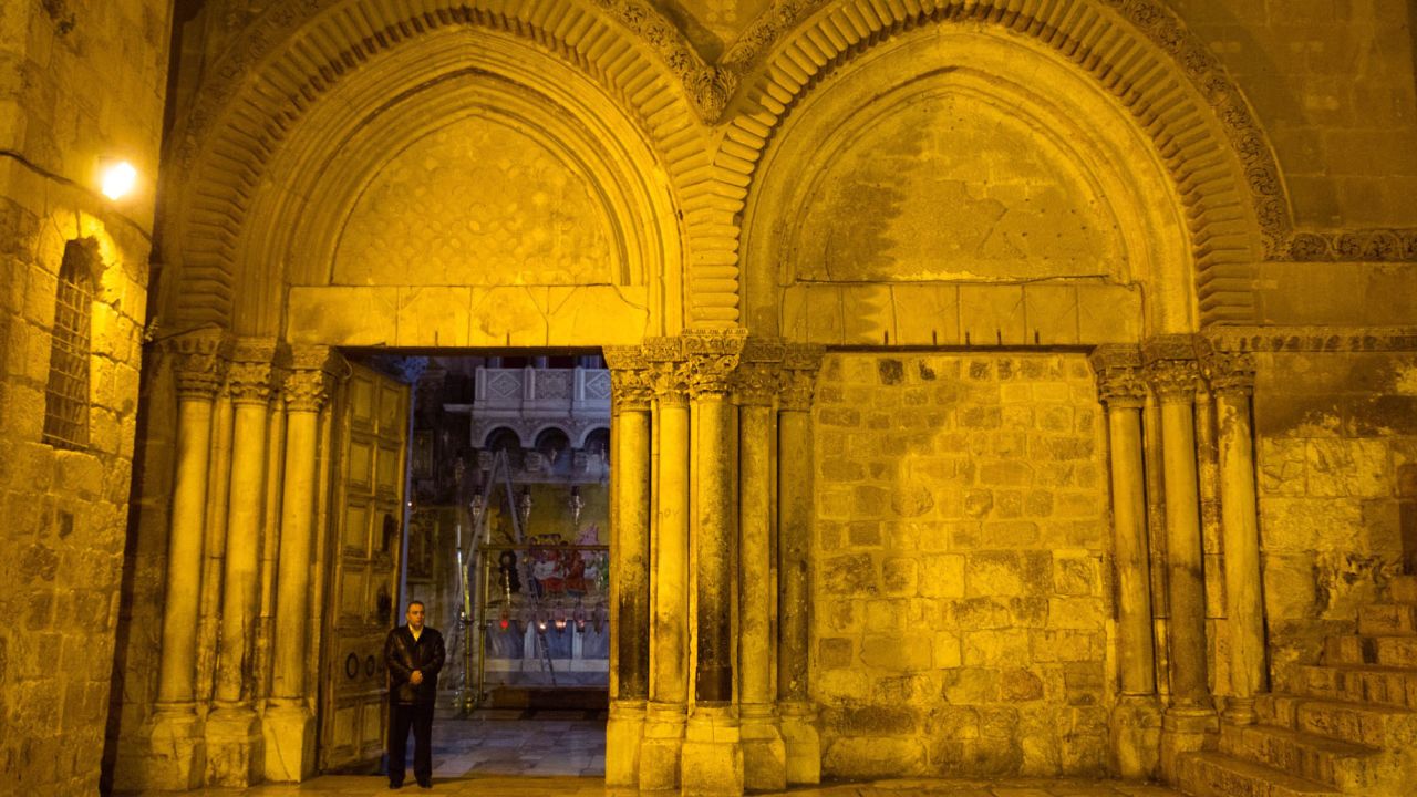 Adeeb Joudeh stands at the entrance to the Church of the Holy Sepulchre on Holy Thursday.