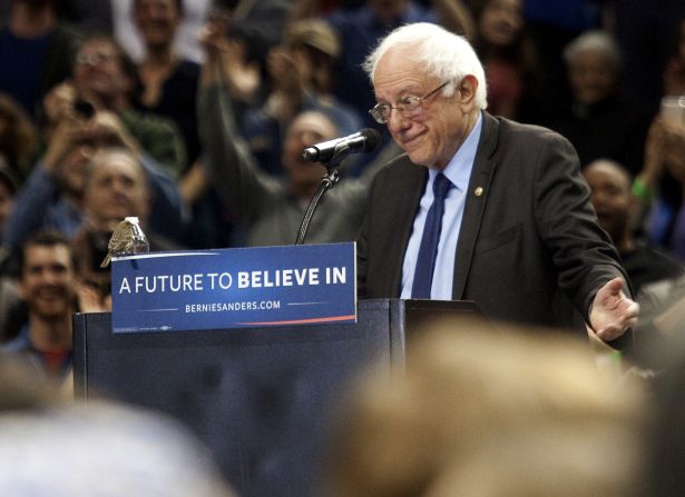 A bird shares the lectern with Democratic presidential candidate Bernie Sanders as he speaks on Friday, March 25, in Portland, Oregon. Sanders spoke to a crowd of more than 11,000.