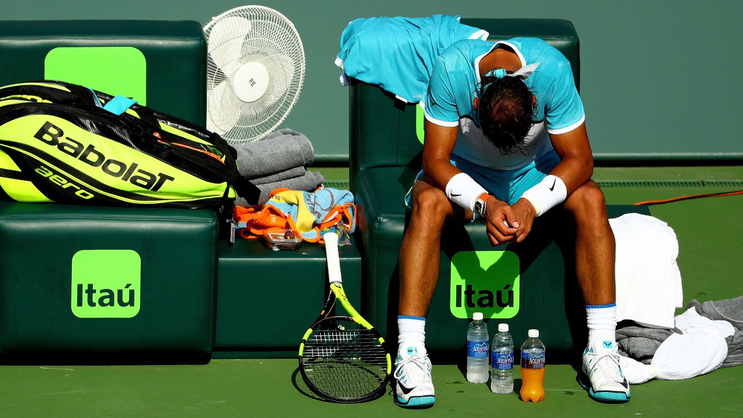 Rafael Nadal of Spain slumps on his chair as he waits for the trainer before retiring in Miami.