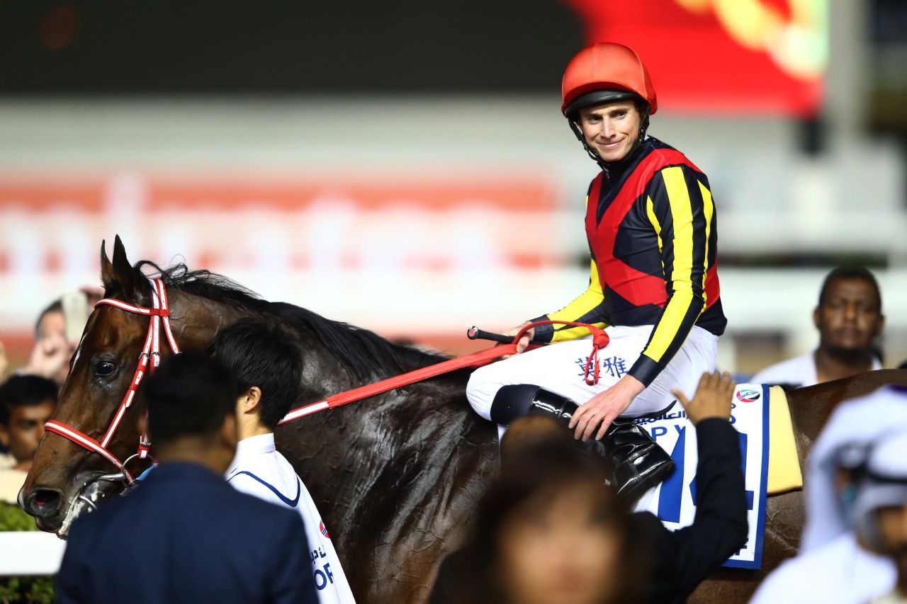 Jockey Ryan Moore celebrates after riding Real Steel to victory in the Dubai Turf at the $30 million World Cup meet. 