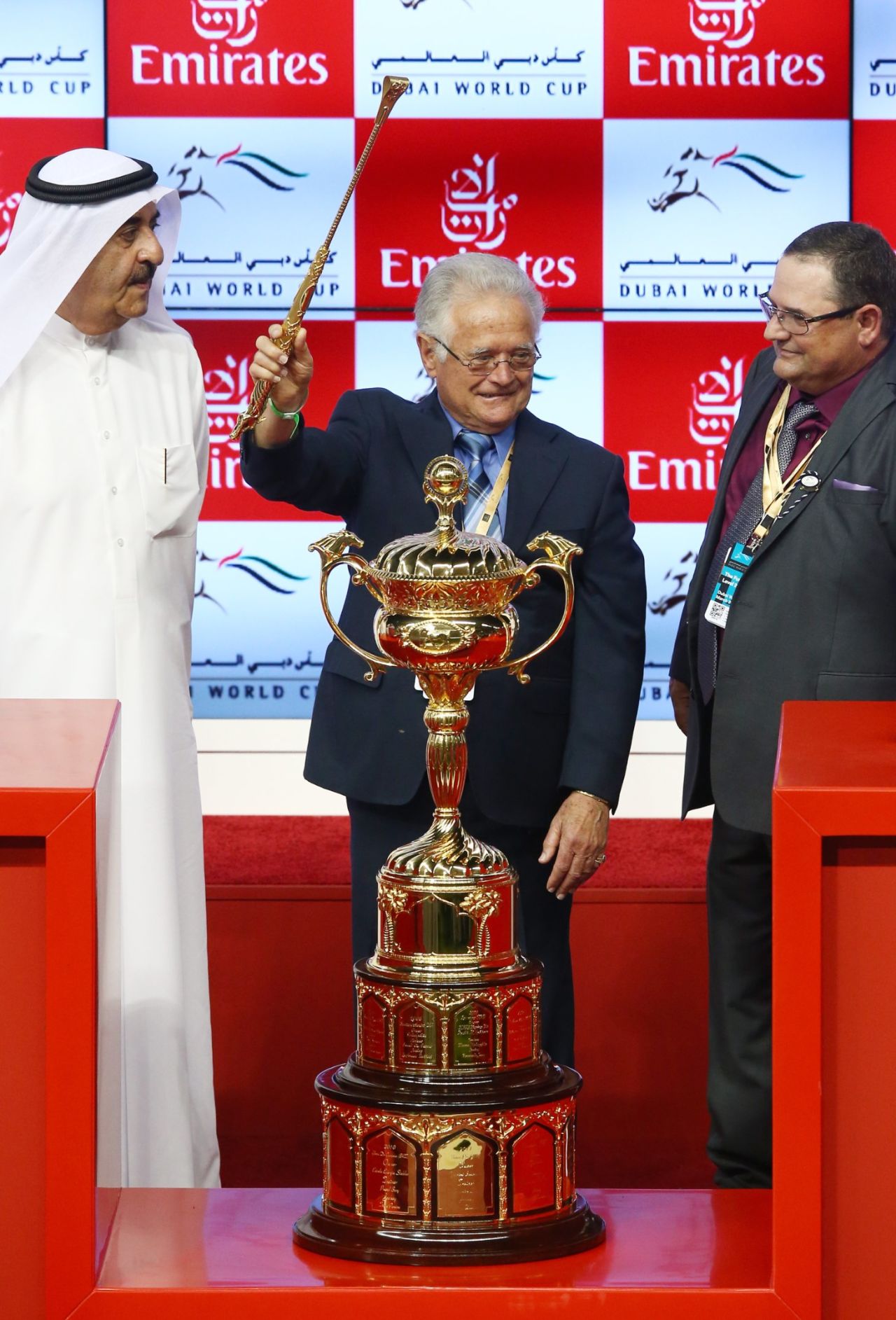 Art Sherman, the legendary trainer of California Chrome, celebrates with the trophy after victory in the Dubai World Cup.