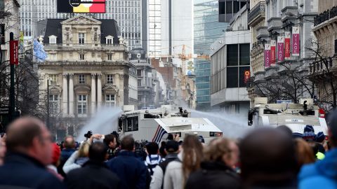 Police use water cannons to disperse anti-immigration protesters Sunday.