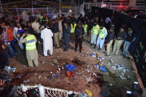 Rescuers and officials gather at the site of the blast. 