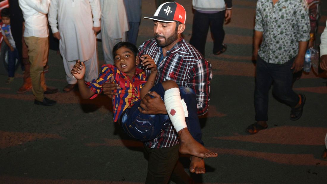 A man carries an injured child away from the scene of the blast. 