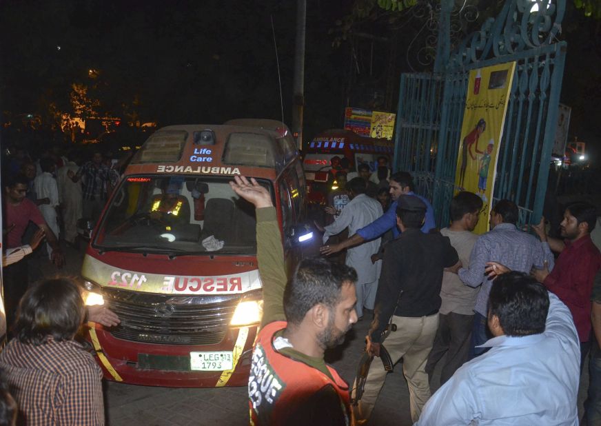 Rescue workers and police gather near the site of the blast.