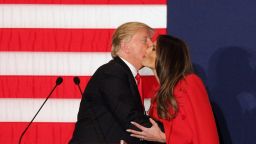 CEDAR RAPIDS, IA - FEBRUARY 1 : Republican presidential candidate Donald Trump kisses his wife wife Melania Trump as his daughter looks on during a campaign event at the U.S. Cellular Convention Center February 1, 2016 in Cedar Rapids, Iowa. Trump who is seeking the nomination for the Republican Party attends his final campaign rally ahead of tonight's Iowa Caucus. (Photo by Joshua Lott/Getty Images)