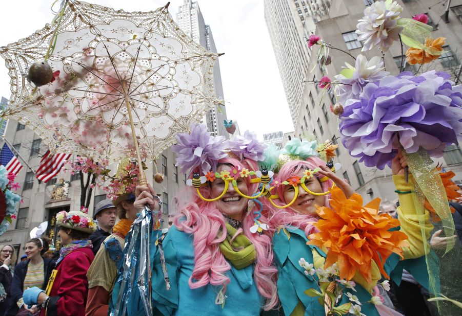 Two women pose for photographers as the parade makes its way down Fifth avenue. 