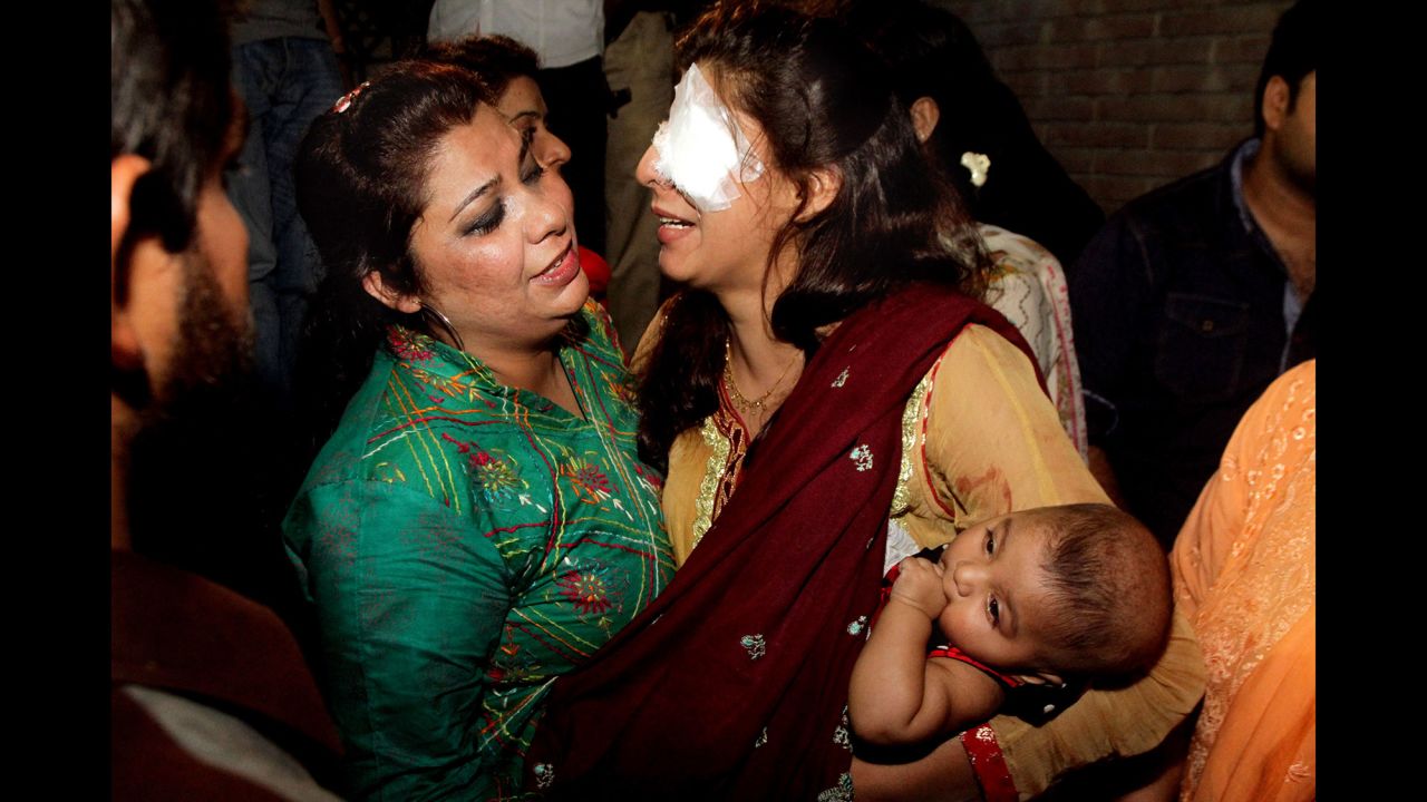 A woman injured in the bomb blast is comforted by a family member at a local hospital in Lahore on March 27.