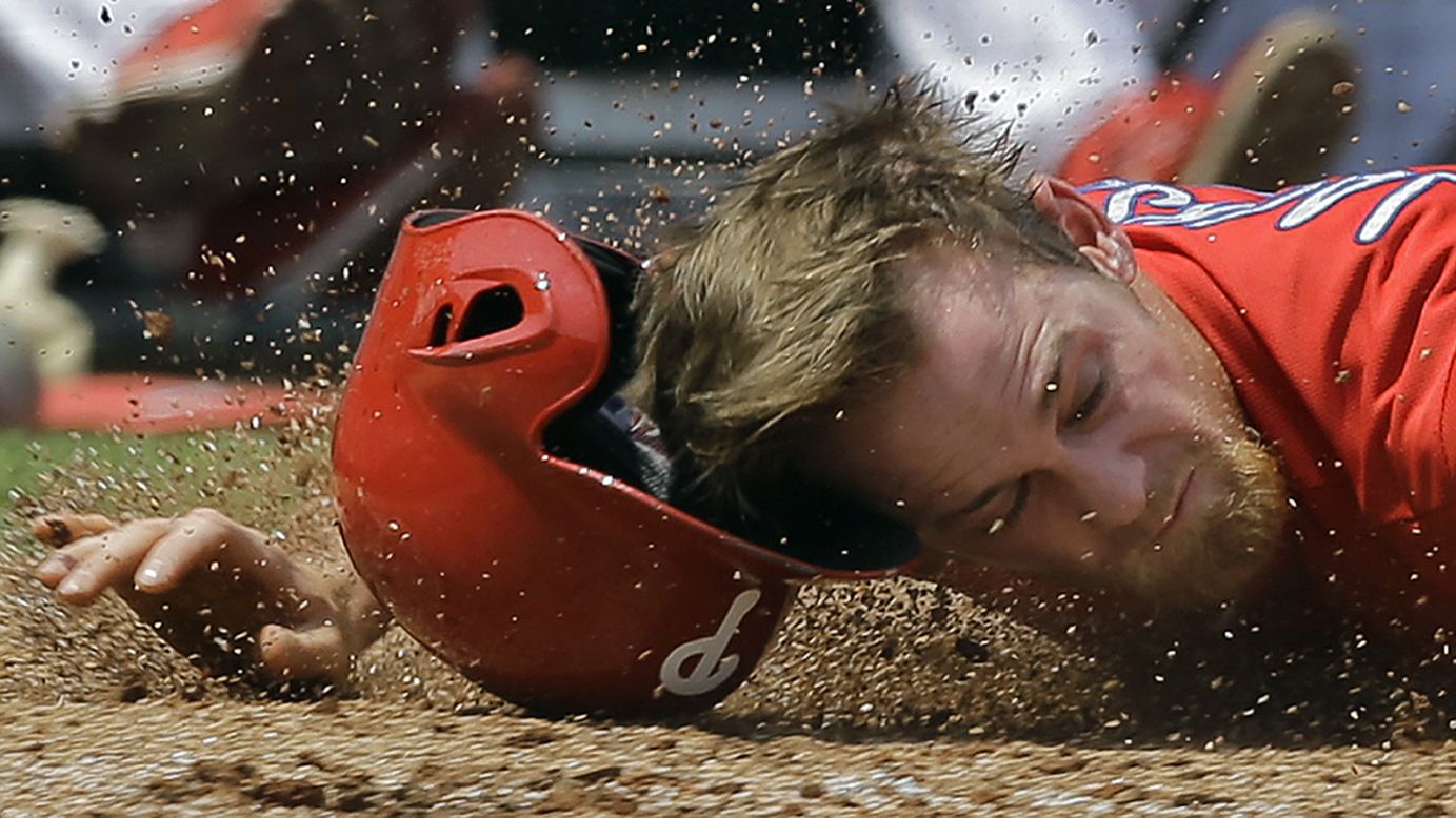 Philadelphia's Ryan Jackson hits the dirt near home plate during a spring-training game in Clearwater, Florida, on Saturday, March 26. He was tagged out on the play.