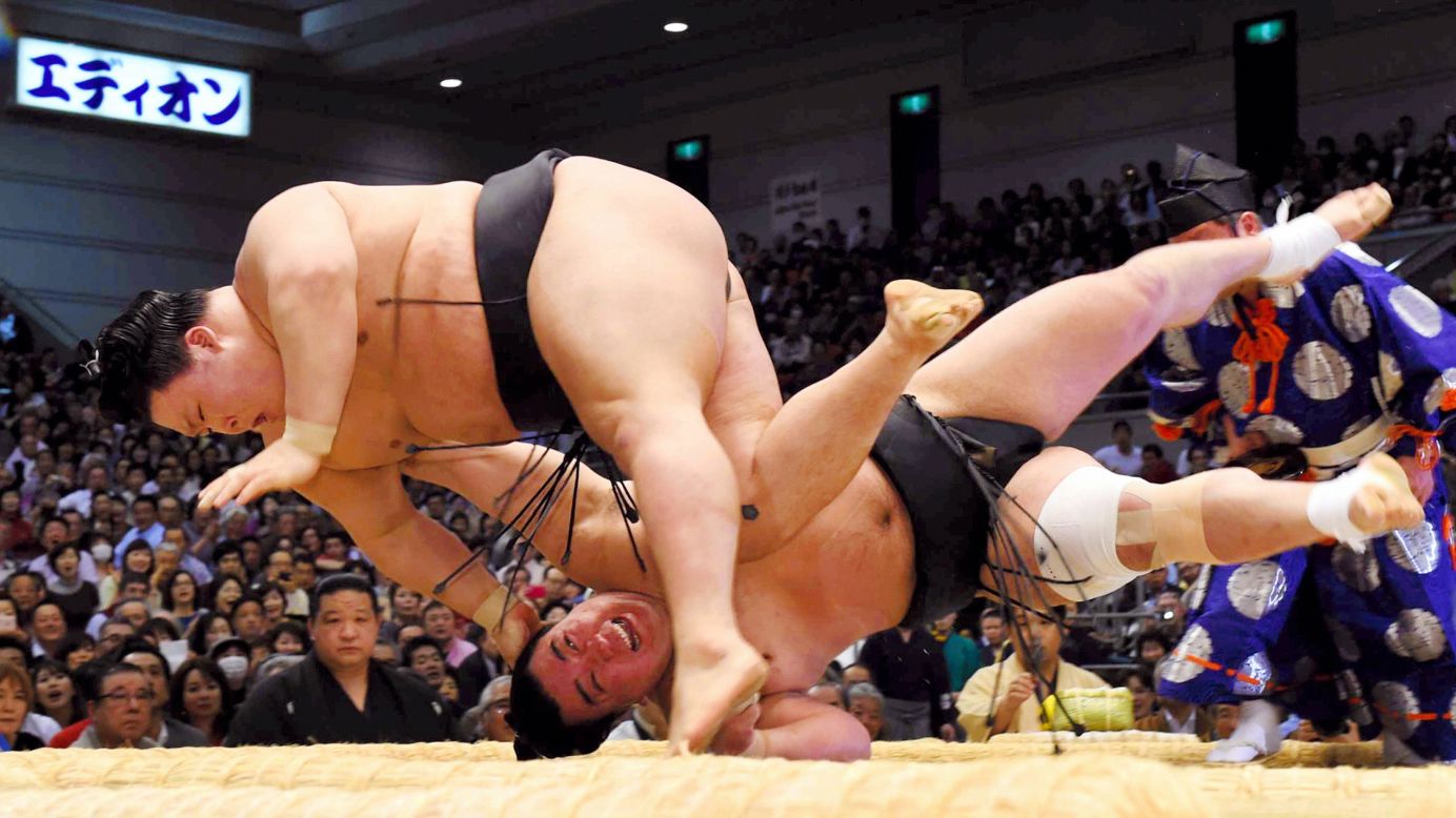 Goeido, above, throws Harumafuji to win a match Wednesday, March 23, at the Grand Sumo Spring Tournament in Osaka, Japan.