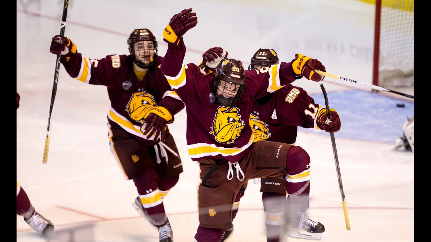 Karson Kuhlman, center, celebrates Friday, March 25, after his goal in double overtime lifted Minnesota-Duluth to the quarterfinals of the NCAA Tournament. The Bulldogs defeated Providence, the defending national champions, by a 2-1 score.