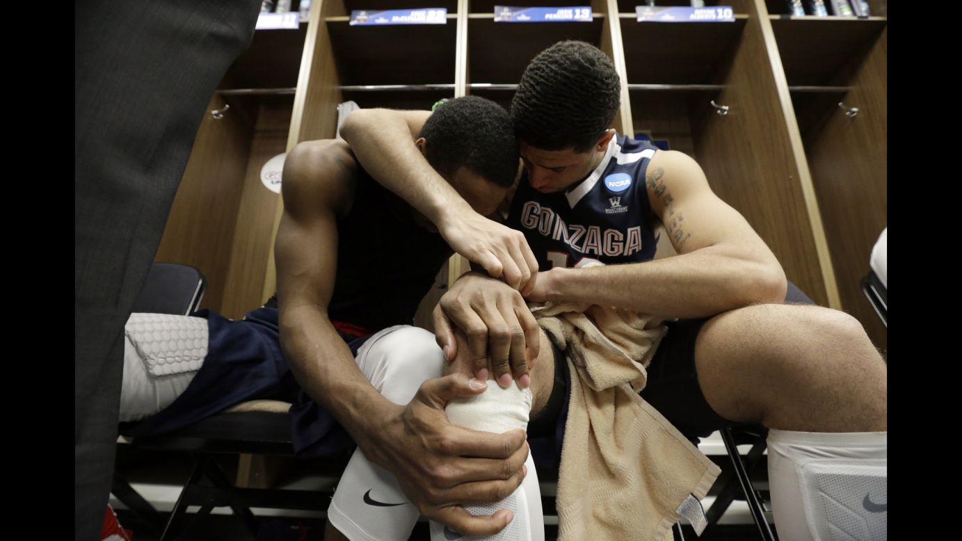 Gonzaga's Eric McClellan, left, and Josh Perkins embrace in the locker room after losing to Syracuse in the NCAA Tournament's Sweet 16 on Friday, March 25.