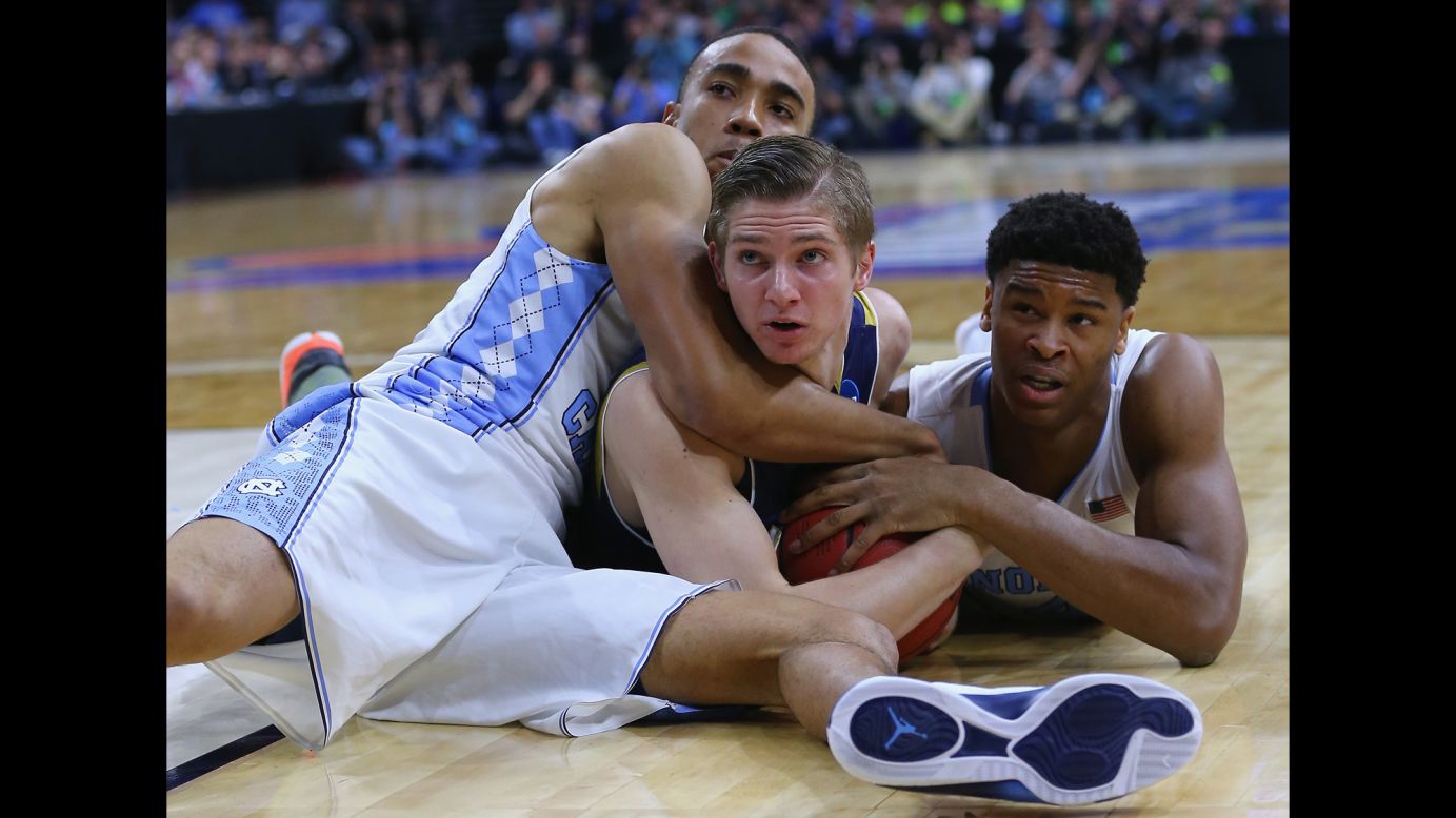 Notre Dame's Rex Pflueger, center, is tied up by North Carolina's Brice Johnson, left, and Isaiah Hicks during their Elite Eight game on Sunday, March 27. North Carolina advanced to the Final Four with an 88-74 victory.