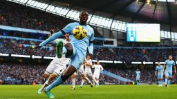MANCHESTER, ENGLAND - NOVEMBER 22: Yaya Toure of Manchester City keeps the ball in play during the Barclays Premier League match between Manchester City and Swansea City at Etihad Stadium on November 22, 2014 in Manchester, England.  (Photo by Jan Kruger/Getty Images)