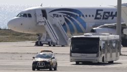 A bus carrying some passengers from the hijacked EgyptAir aircraft as it landed at Larnaca airport Tuesday, March 29, 2016. The EgyptAir plane was hijacked on Tuesday while flying from the Egyptian Mediterranean coastal city of Alexandria to the capital, Cairo, and later landed in Cyprus where some of the women and children were allowed to get off the aircraft, according to Egyptian and Cypriot officials. (AP Photo/Petros Karadjias)