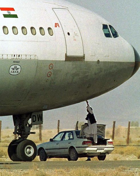 A Taliban security official receives a paper on which the hijackers of Indian Airlines flight IC-814 have put their demands at Kandahar Airport in this photo, taken on December 27, 1999. The New Delhi-bound flight with 157 people on board was hijacked to the southern Afghan city of Kandahar by five men after it took off from Kathmandu, Nepal, on December 24. One person was killed.
