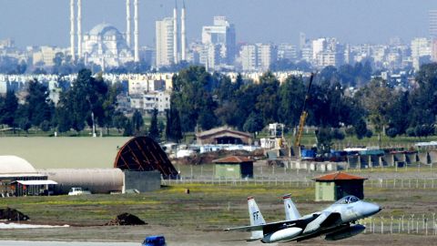 An F-15 fighter jet glides in for a landing in front of Adana's main mosque March 7, 2003 at Incirlik Air Force Base in Turkey.