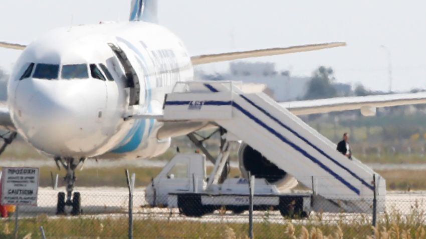 A man believed to be the hijacker of the EgyptAir Airbus A-320, which was diverted to Cyprus, leaves the plane on March 29, 2016. 
The hijacker who seized the Egyptian airliner and forced it to land in Cyprus has been detained, Cypriot government spokesman Nicos Christodoulides said. / AFP / BEHROUZ MEHRI        (Photo credit should read BEHROUZ MEHRI/AFP/Getty Images)