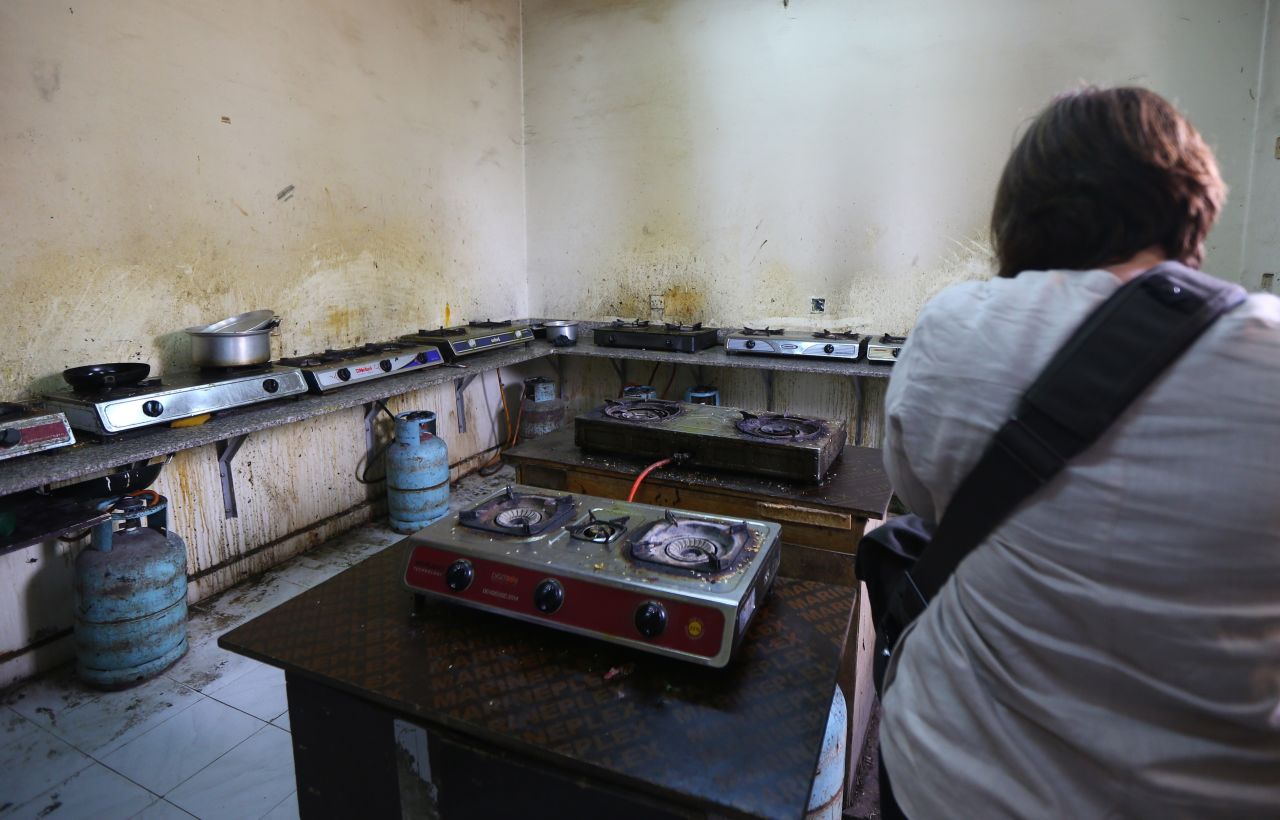 Here, a reporter takes a picture of a squalid kitchen at a camp housing foreign workers in Doha in May 2015. The Qatari government has announced new projects to provide better accommodation.