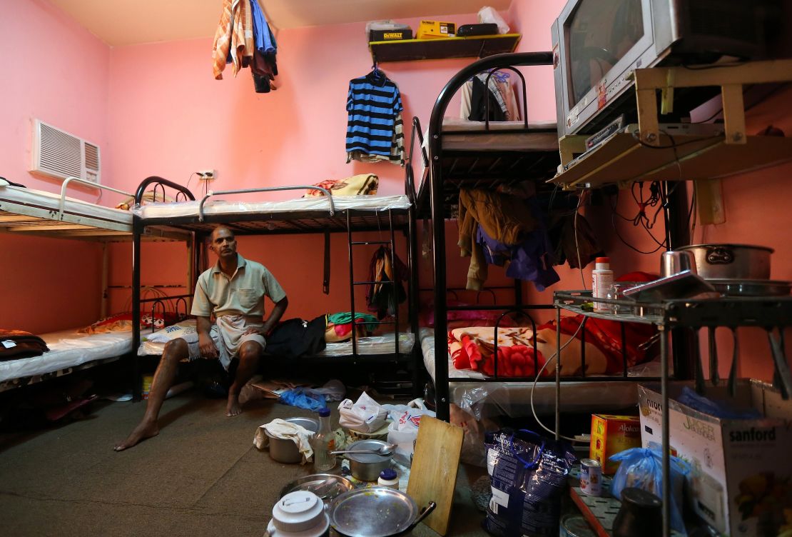 Kupttamon, an Indian laborer working in Qatar, sits in his room at a private camp housing foreign workers in Doha, on May 3, 2015. 