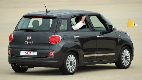 The Pope waves from a Fiat last year. A similar car that was used by the pontiff is up for auction.