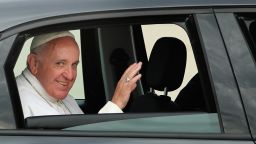 Pope Francis waves from his car, a Fiat, upon arrival at Andrews Air Force Base in Maryland in September. The Archdiocese of New York is now auctioning off the car for charity.