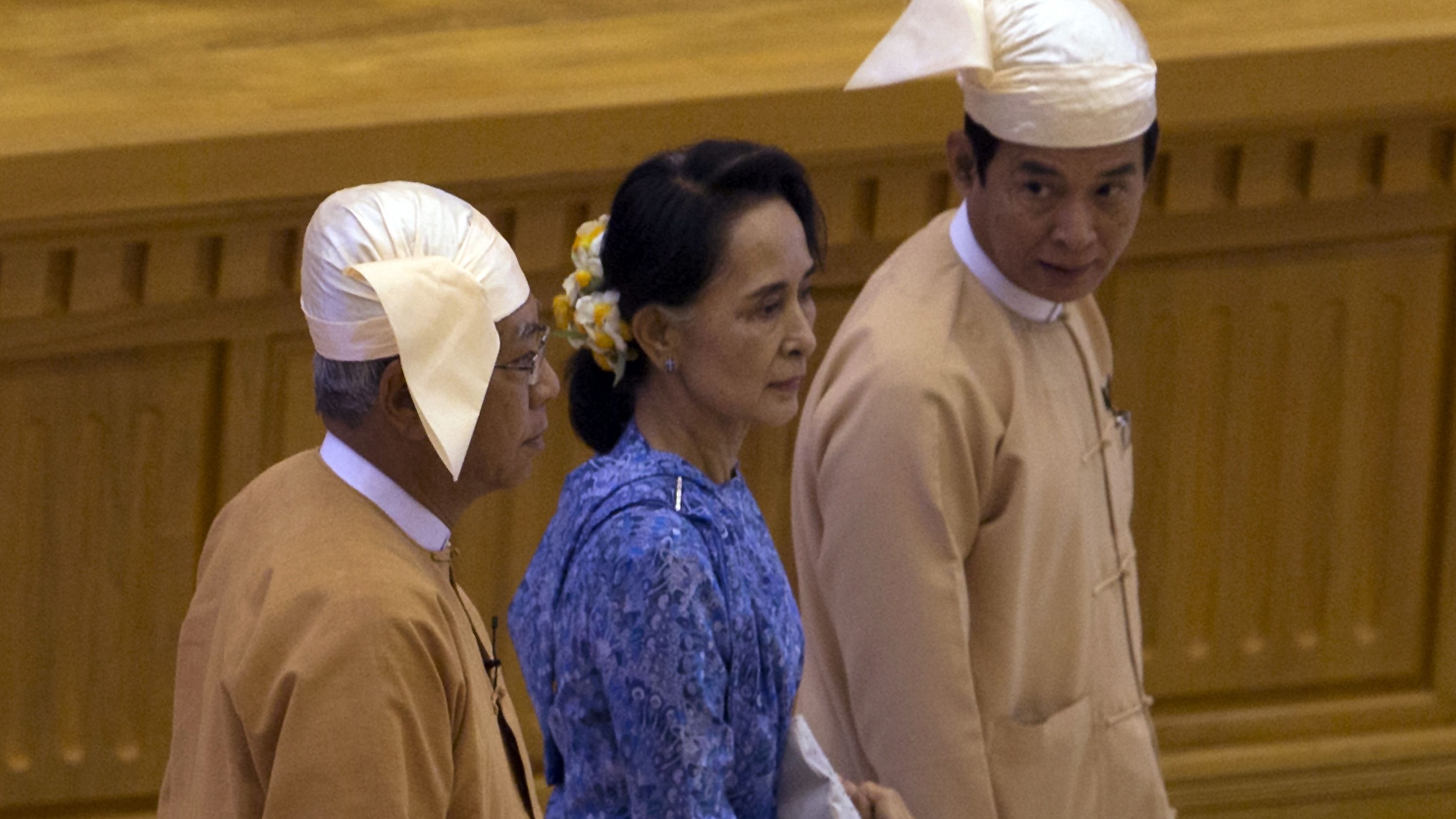 Htin Kyaw, left, walks with Aung San Suu Kyi at his swearing in ceremony.