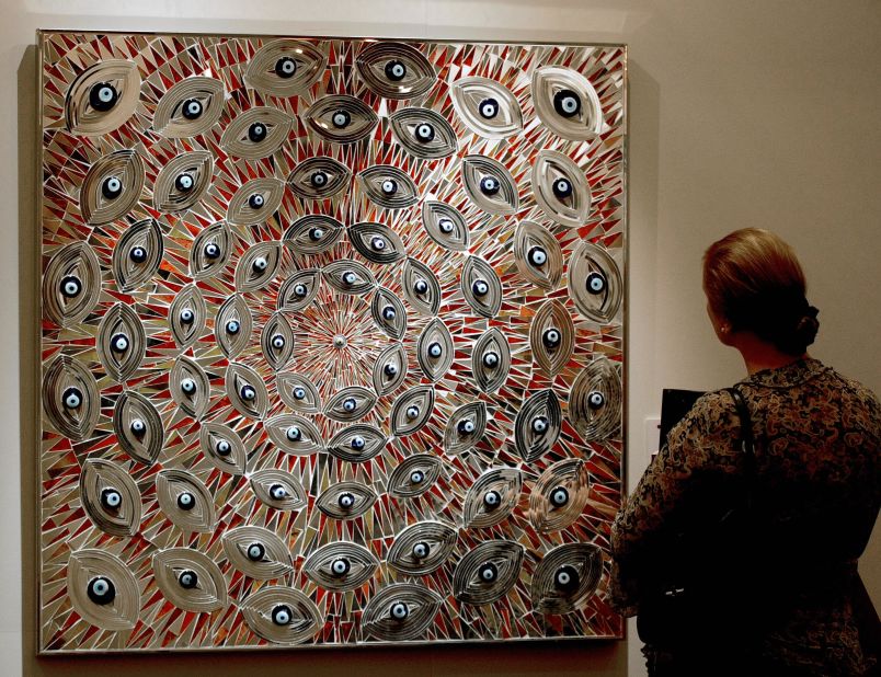 A woman admires an untitled painting by Iranian artist Mounir Farmanfarmaian at an exhibition by Christie's auction house in Dubai in 2009. 