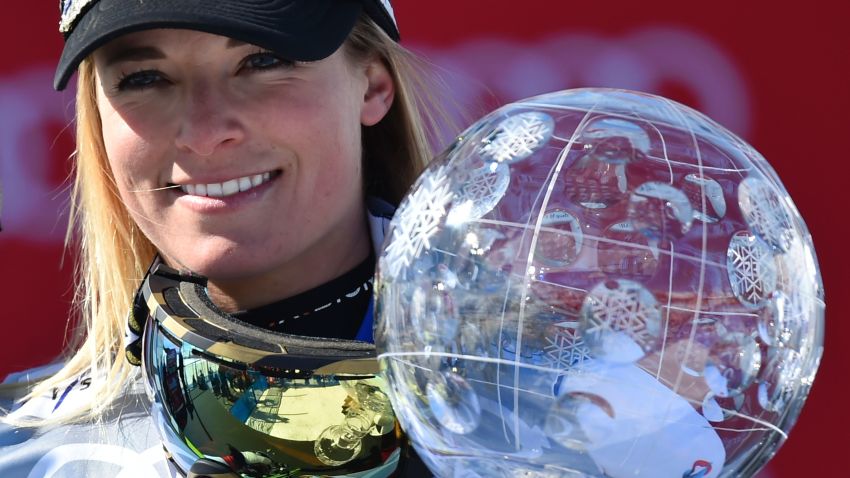Switzerland's Lara Gut holds the Ladies' crystal globe trophy on the podium of the FIS Alpine Skiing World Cup in St Moritz on March 20, 2016.  AFP PHOTO / FABRICE COFFRINI / AFP / FABRICE COFFRINI        (Photo credit should read FABRICE COFFRINI/AFP/Getty Images)