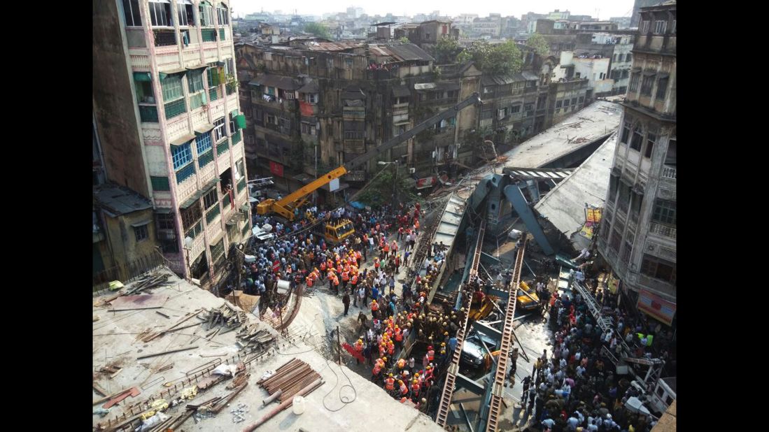 Residents and rescue workers clear rubble after the collapse.