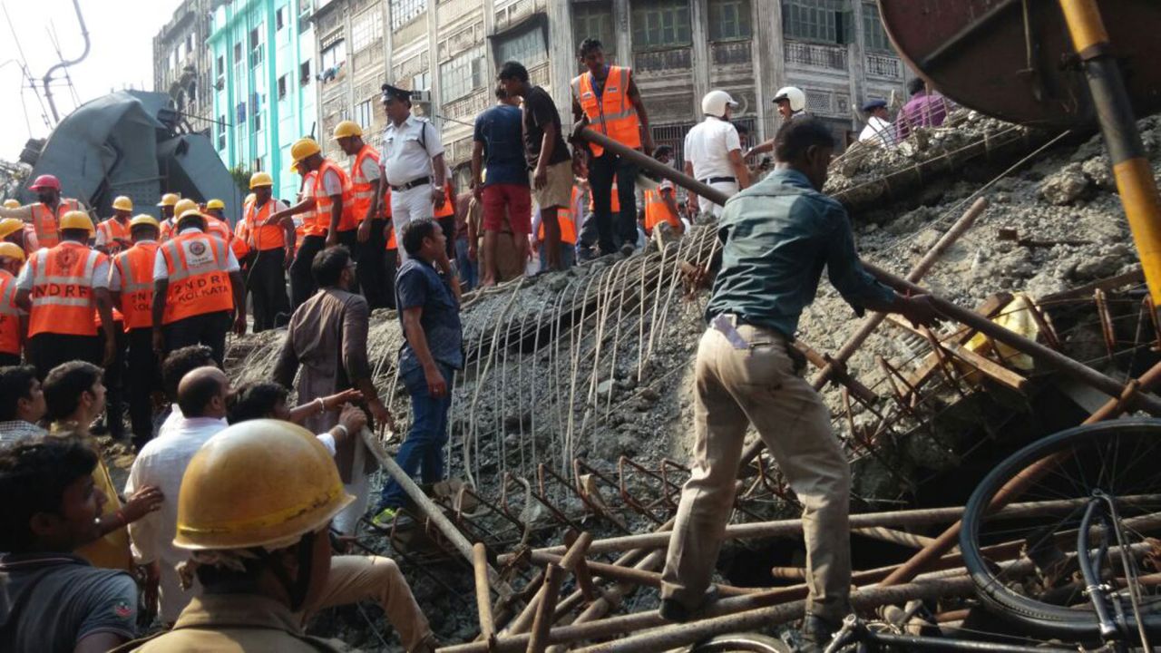 Rescue workers and residents work to clear the rubble on March 31.