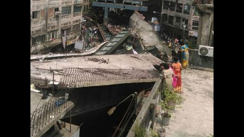 People look at the collapsed overpass. India's army and the National Disaster Response Force sent teams to the site.