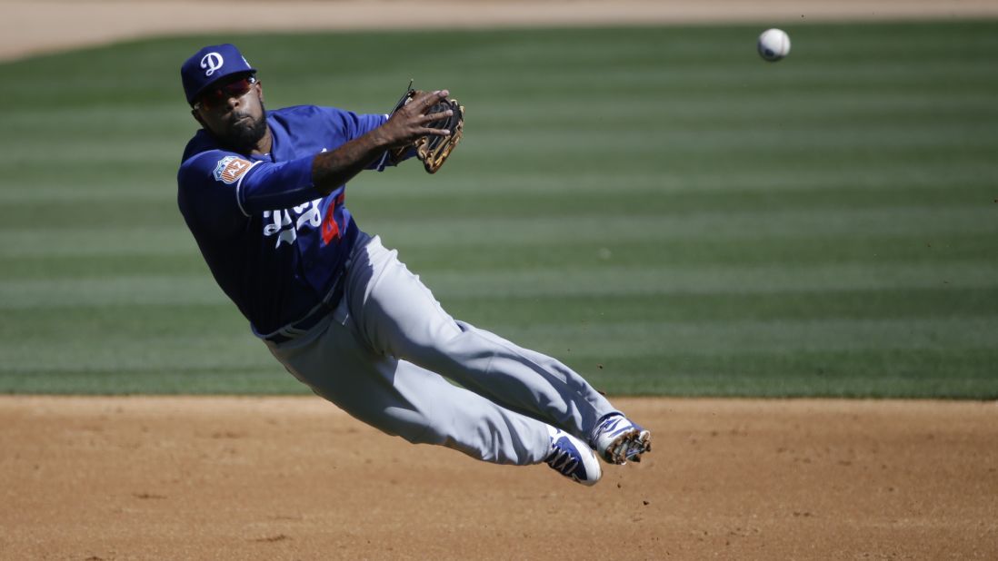 Los Angeles Dodgers second baseman Howie Kendrick throws to first base during a game in Phoenix on March 19.