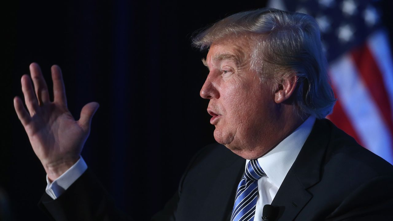 Donald Trump (L), chairman and president of The Trump Organization, speaks during a discussion at the Economic Club of Washington, December 15, 2014 in Washington, DC.