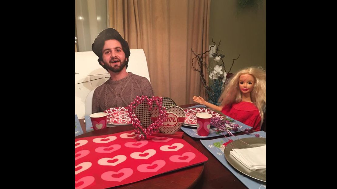 Susan Talley props up the flat Dalton to have dinner with a Barbie doll.