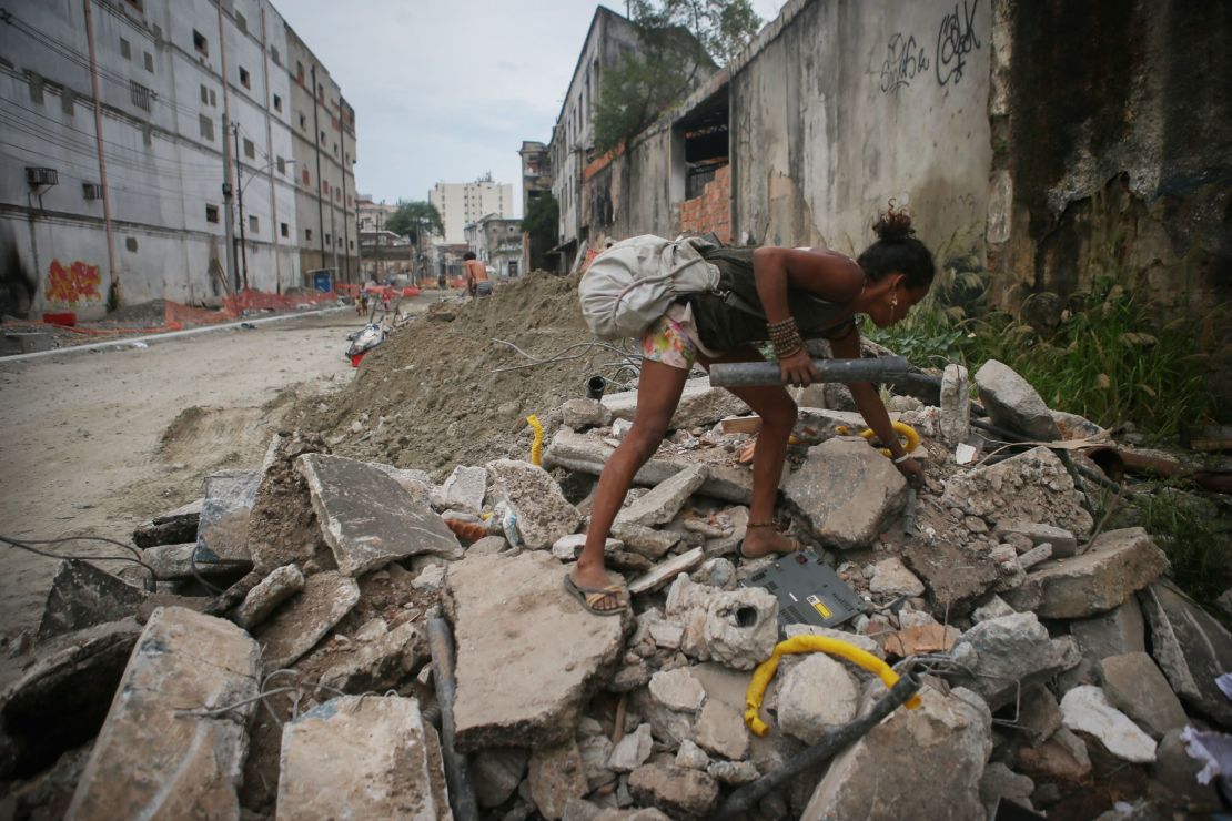 A Brazilian woman collects scrap for recycling in a downtrodden area of Rio de Janeiro.