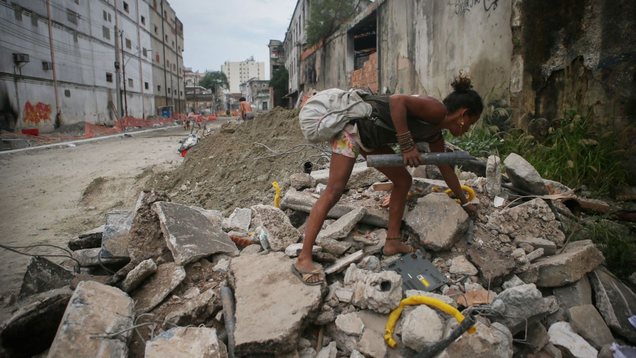 A Brazilian woman collects scrap for recycling in a downtrodden area of Rio de Janeiro.
