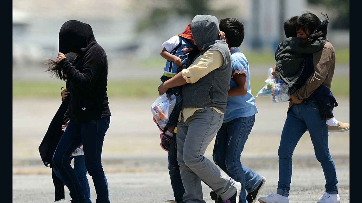 Immigrant children and their mothers arrive in Guatemala after being deported from the United States in 2014. The migrants had come to the U.S. to flee a humanitarian crisis in their homeland.