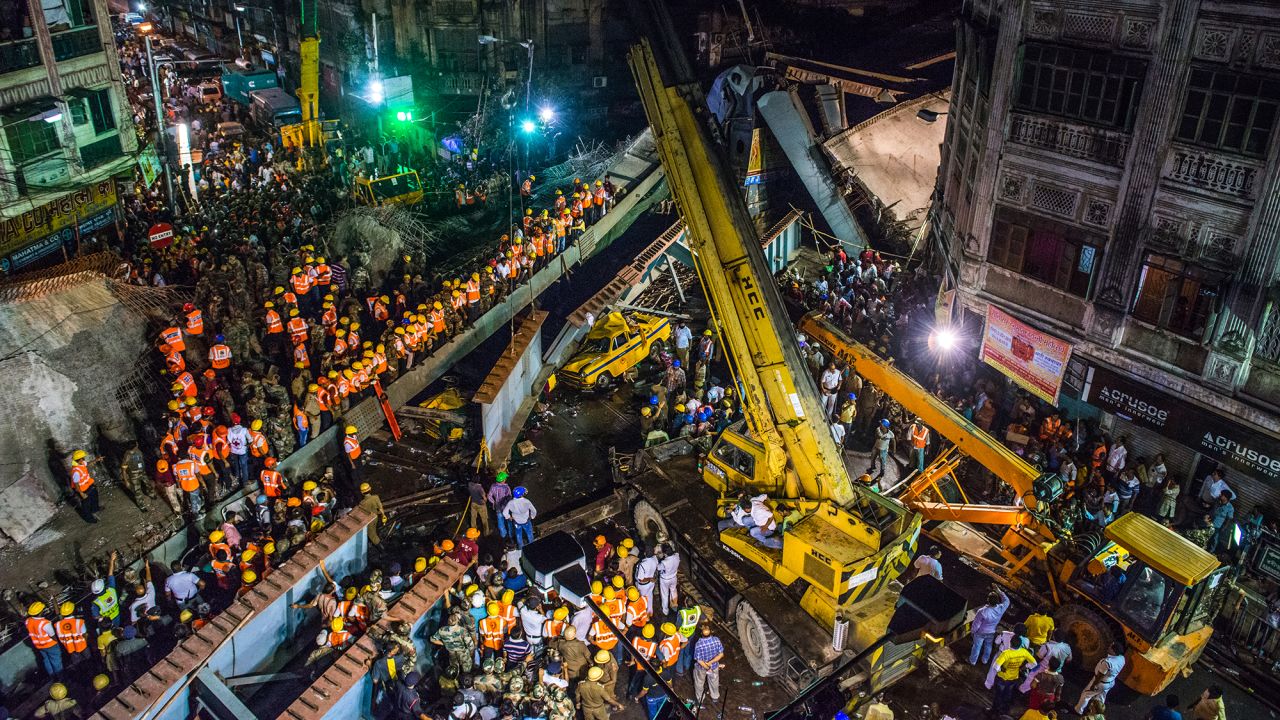 Rescue workers and volunteers work through the night to free people who got trapped under a collapsed overpass in Kolkata, India, on Thursday, March 31. At least 24 people were killed.