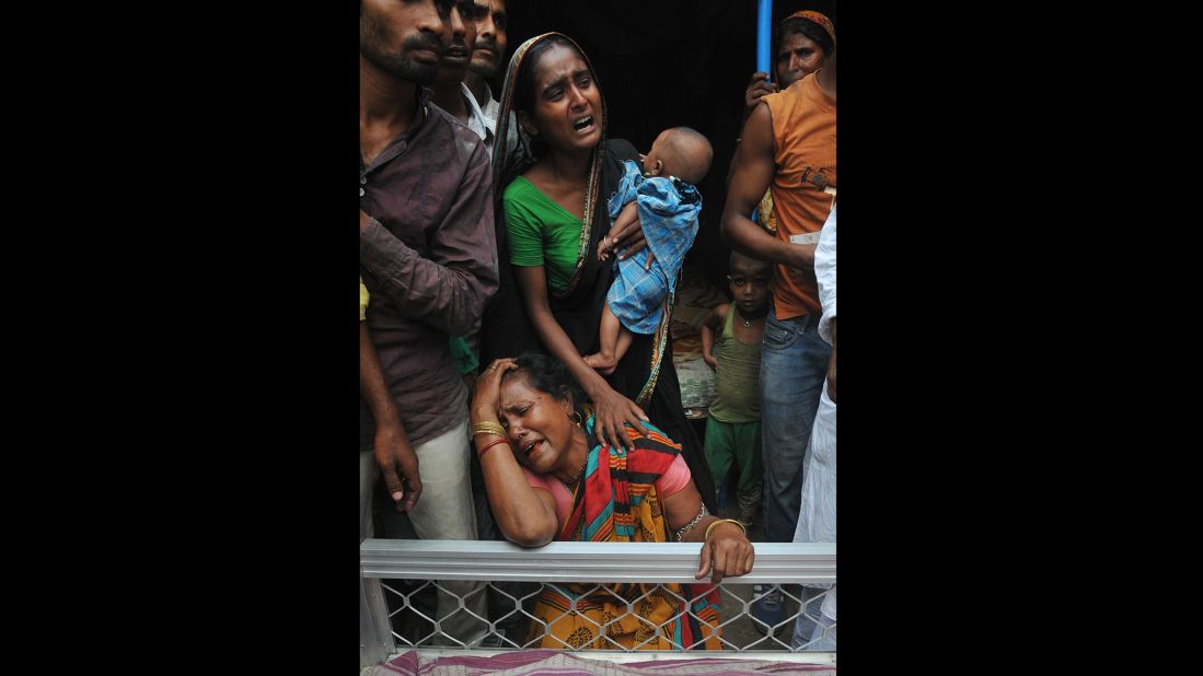 Relatives of a man killed in the collapse mourn next to his body on April 1. 