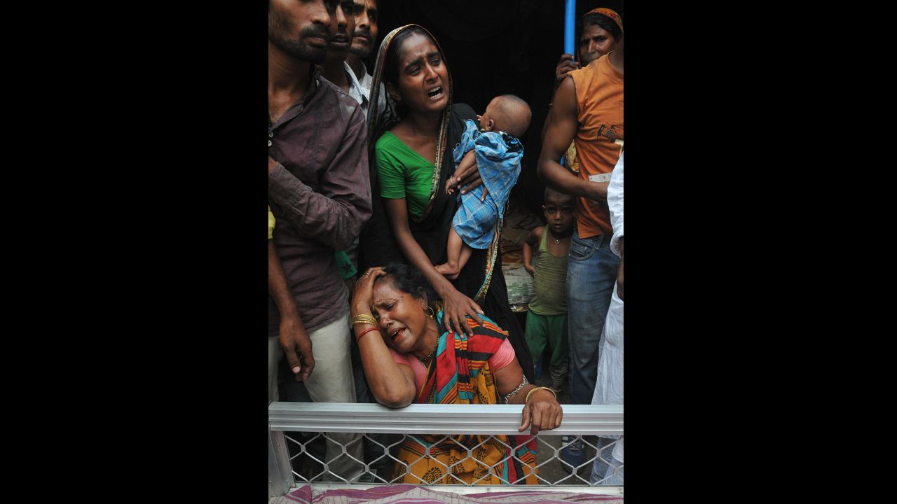 Relatives of a man killed in the collapse mourn next to his body on April 1. 