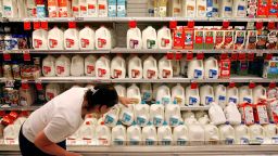 WASHINGTON - AUGUST 20:  A customer scans the expiration date on gallons of milk sitting on a cooler shelf at a Safeway grocery store August 20, 2007 in Washington, DC. The U.S. Labor Department released inflation data showing that U.S. food prices rose by 4.2 percent for the 12 months ending in July. According to the department's consumer price index, the price of milk has increased by 13.3 percent from June 2006 to June 2007.  (Photo by Chip Somodevilla/Getty Images)