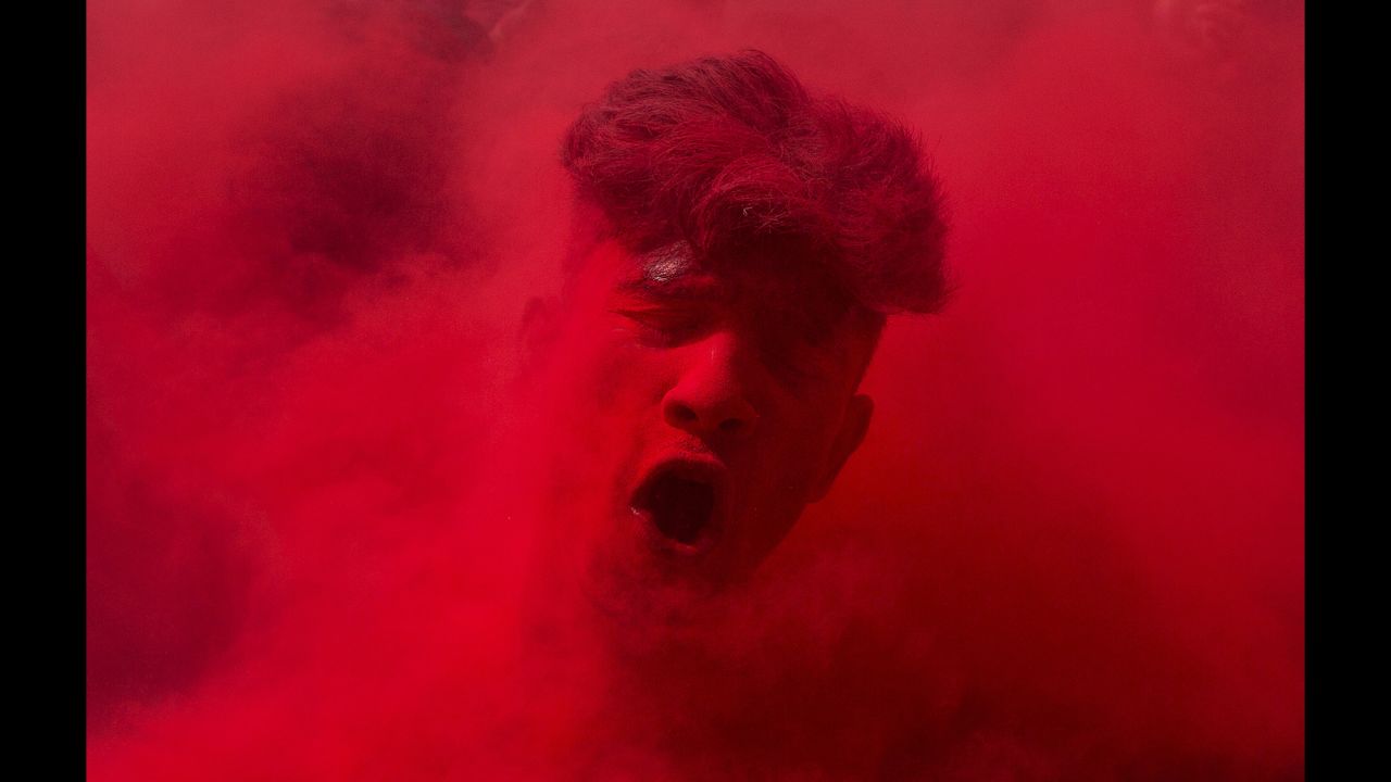 Face smeared with colored powder, a reveler dances during celebrations marking Holi, the Hindu festival of colors. This year the festival fell on March 24. 