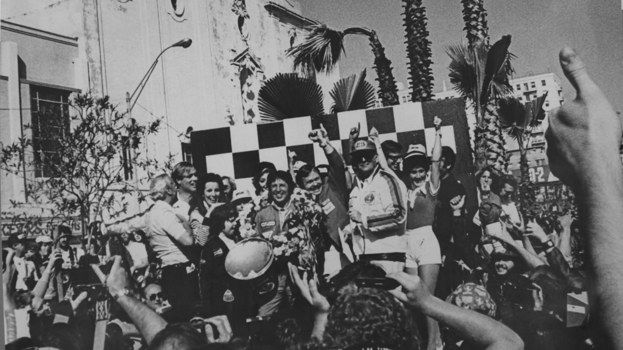 Happy days! Mario Andretti celebrates his win at the 1977 United States GP West at Long Beach. 