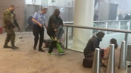 BRUSSELS, BELGIUM - MARCH 22:  Wounded passengers are treated following a suicide bombing at Brussels Zaventem airport on March 22, 2016 in Brussels, Belgium. Georgian journalist Ketevan Kardava, special correspondent for the Georgian Public Broadcaster, was travelling to Geneva when the attack took place, she was knocked to the floor and began to take photographs in the moments that followed. At least 31 people were killed and more than 260 injured in a twin suicide blast at Zaventem Airport and a further bomb attack at Maelbeek Metro Station. Two brothers are thought to have carried out the attacks and a manhunt is underway for a third suspect.   (Photo by Ketevan Kardava/Getty Images)
