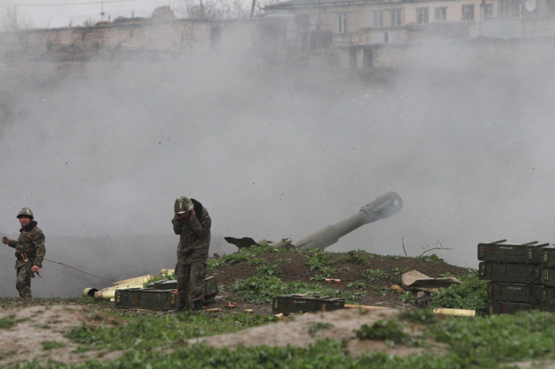 Armenian servicemen fire an artillery shell towards Azeri forces from the town of Martakert on Sunday.