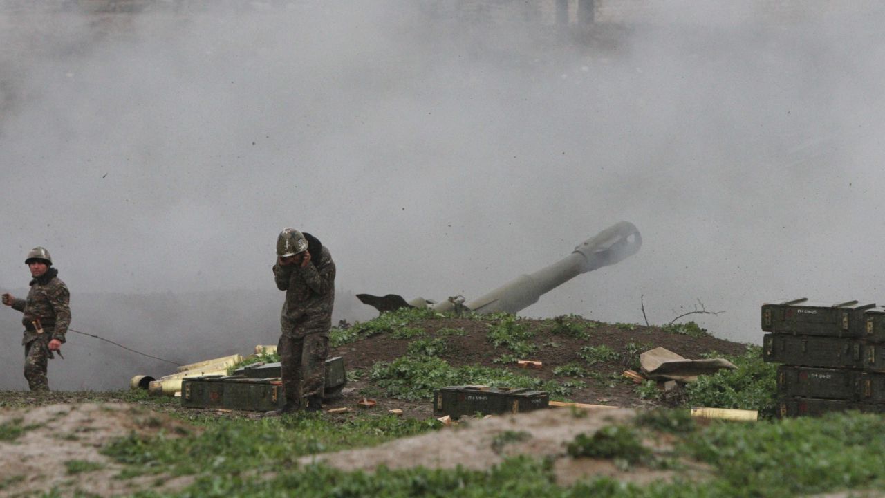 Armenian servicemen fire an artillery shell towards Azeri forces from the town of Martakert on Sunday.