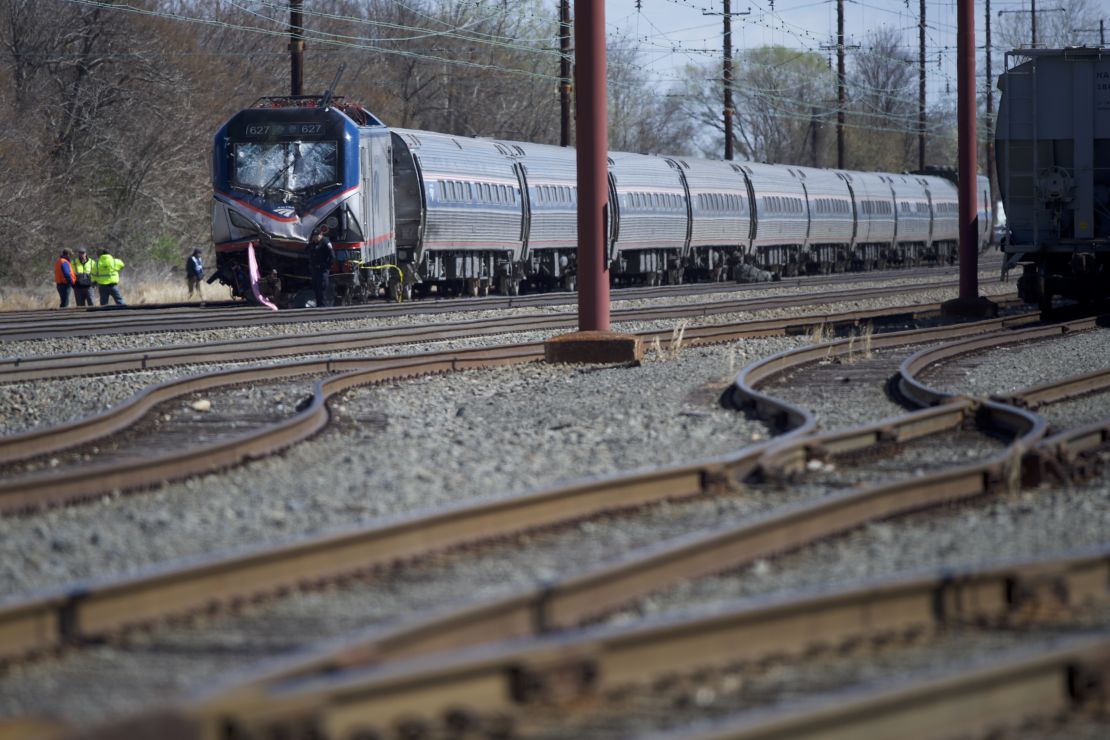 Emergency crews investigate the site of Sunday's Amtrak train crash near Philadelphia.