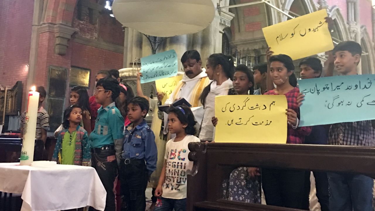 Children hold up placards condemning terrorism at a special service for the victims of the Gulshan Iqbal Park attack.